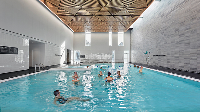 People swimming in the indoor leisure pool at the Bernie Morelli Recreation Centre